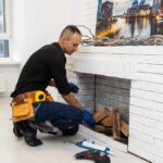 Service,Technician,Repairing,A,Fireplace,In,A,Home