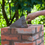 Masonry,Works,,Male,Hand,Working,With,A,Trowel,,Repairing,A
